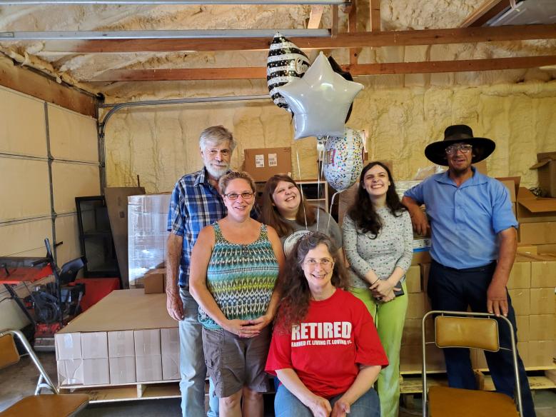 Group of people with balloons indoors.