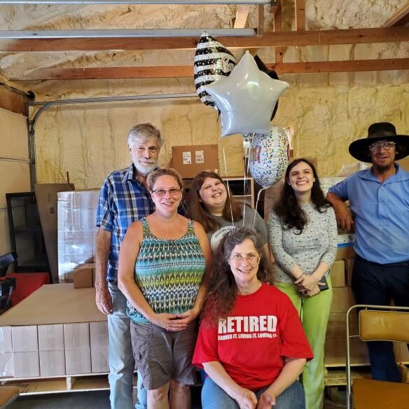 Group of people with balloons indoors.